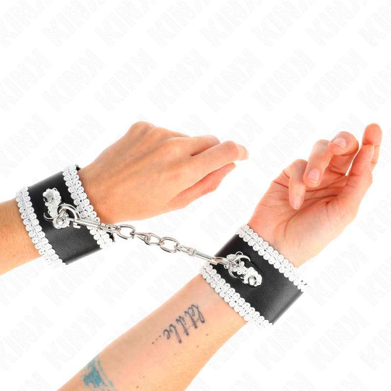 KINK - BLACK WRIST RESTRAINTS WITH WHITE DECORATE LACE ADJSUTABLE 20-23 CM X 5.5 CM KINK - BLACK WRIST RESTRAINTS WITH WHITE DECORATE LACE ADJSUTABLE 20-23 CM X 5.5 CM